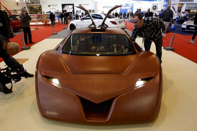 Harmon, designer of the "Splinter", a concept car made for 90 percent of wood composites, looks at his car at the Essen Motor Show in Essen