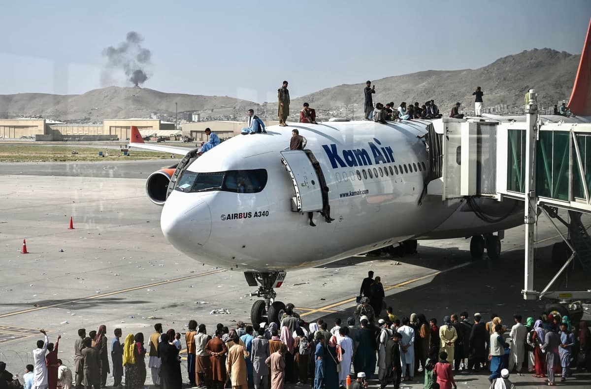 Афғонистонни тарк этмоқчи бўлган афғонистонликлар Кобулдаги аэропортдаги самолётга чиқиб олган.