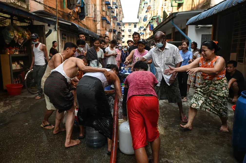 Мьянманинг Янгон шаҳрида одамлар идишларга сув олмоқда. Шаҳардаги электр таъминотидаги узилишлар туфайли минглаб одамлар сув танқислигига дуч келишмоқда.