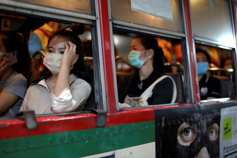 Tailand poytaxti Bangkokda jamoat transportida niqob taqib ketayotgan ayollar.