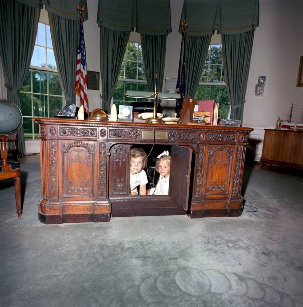 Керолин ва Кэрри Кеннеди “Резолют” столи тагига кириб олган, 1963 йил.