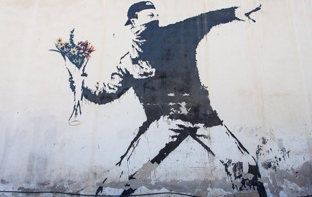 Benksining Falastin va Isroil o‘rtasidagi devorga chizgan Flower Thrower (Gul otuvchi) graffiti
