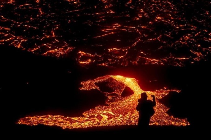 Исландиянинг Рейкянес яриморолидаги вулқондан оқаётган лава.