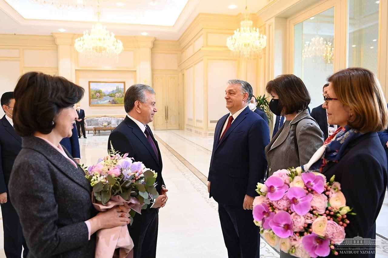 Prezident Shavkat Mirziyoyev va Vengriya bosh vaziri Viktor Orban muloqot qilmoqda, ularning rafiqalari esa gul tutib turibdi. 2021-yil 30-mart.