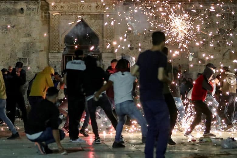 Quddusdagi Al-Aqso masjidi yaqinida Isroillik politsiyachilarga qarshi kurashayotgan falastinliklar.