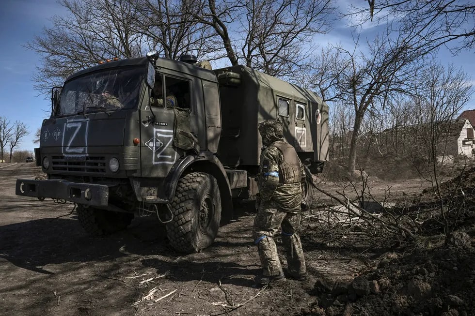 Ukrainalik askarlar qo‘lga olingan rus armiyasi yuk mashinasini haydab ketmoqda. 2022 yil 28 mart
