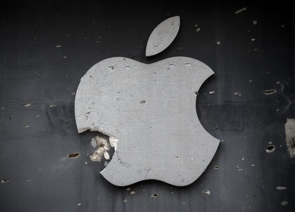 Kompyuter texnikalari do‘koni devorida o‘q izlari qolgan Apple logotipi.