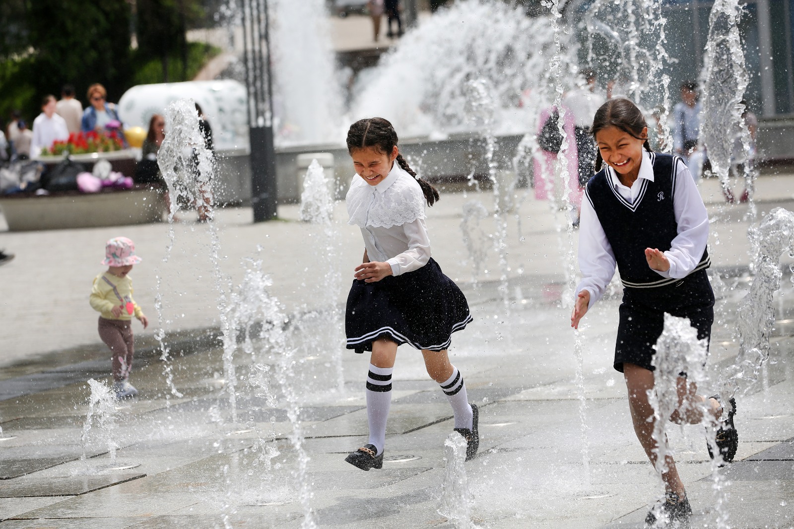 Young Kazakh girls playing in the fountains