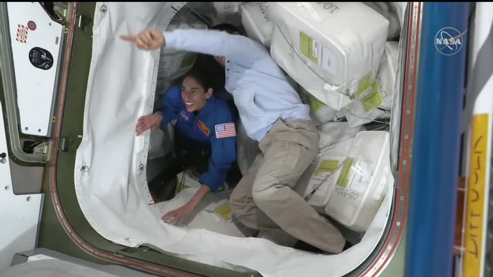 New international team arrives at ISS via Dragon spacecraft.
