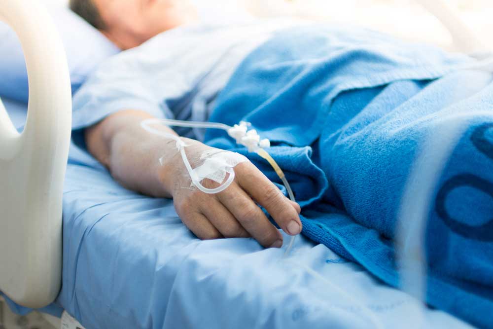 Patient lies in hospital bed