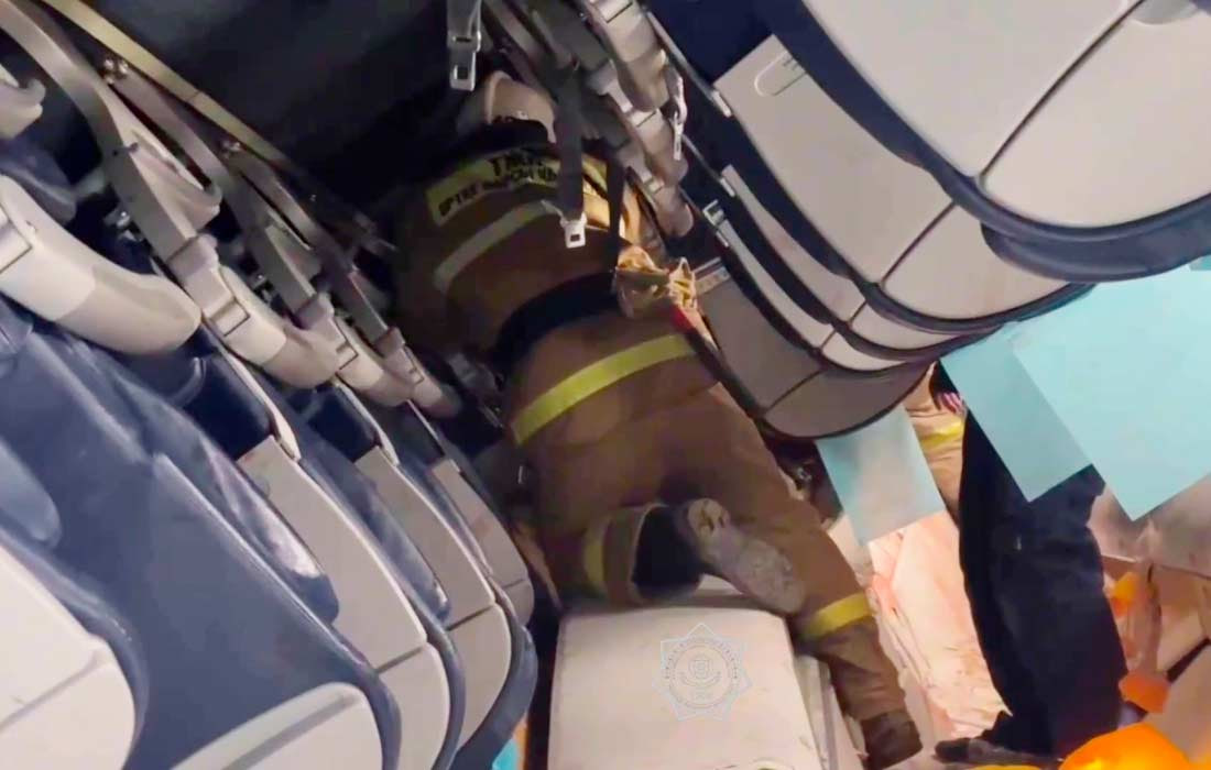 Firefighter working in the cabin of the Embraer plane that crashed in Kazakhstan, as the transcript of AZAL pilots’ conversations is being analyzed.